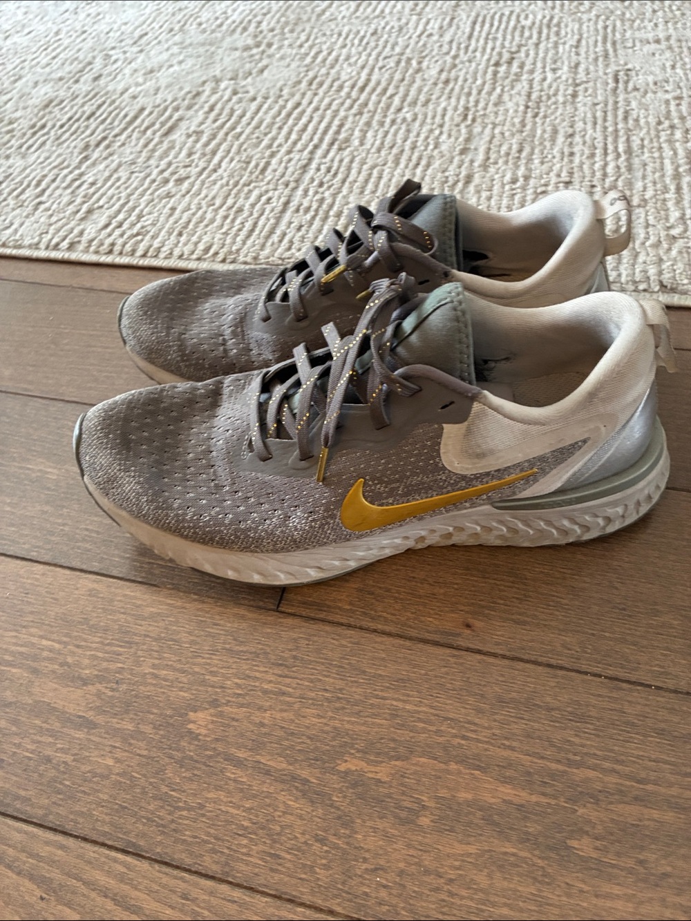 Nike Women's Gray Athletic Running Shoes with Gold Swoosh